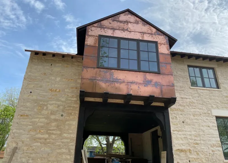 Copper metal panel facade on a stone building for Skylight Installation in Danbury